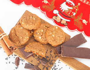 Ginger cookies with chocolate and red napkin with Santa Claus.