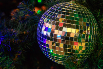 Magic Christmas ball of mirror pieces on an artificial Christmas tree close