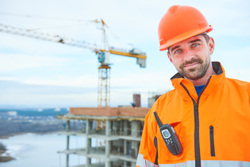 happy builder worker at construction site