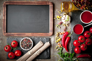 Raw pasta in the composition on the table with items for cooking