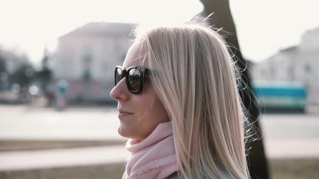 Portrait of confident Caucasian woman leader 30s. Slow motion calm smiling attractive female walking in stylish clothes.