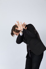 Male protecting face from violent attack. Adult caucasian man covering face and head to stop punches in a fight from attacker.