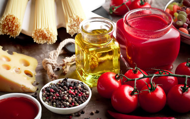Raw pasta in the composition on the table with items for cooking