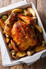 Homemade food: baked chicken with mushrooms and potatoes close-up. vertical top view