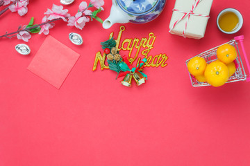 Flat lay image of items decoration & ornaments for Chinese new year and Lunar holiday background concept.Difference accessory on the red wooden at office desk.objects for mock up and template design.