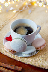 Colorful macaroons and coffee cup. Christmas card.