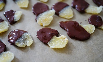 Making candied ginger dipped in dark chocolate