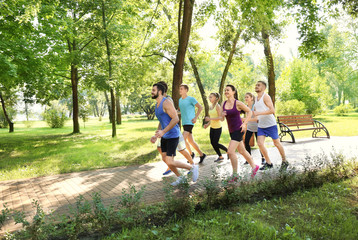 Fototapeta premium Group of young people running in park