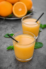 Glasses of fresh orange juice on table