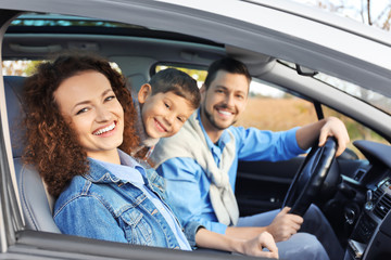 Young family with child in car