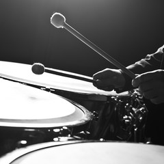 Hands musician playing the timpani closeup in black and white
