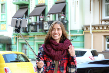 Young beautiful woman taking selfie outdoors