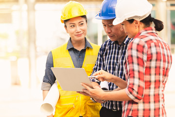 Engineers technology man and woman working on notebook plan building construction in city