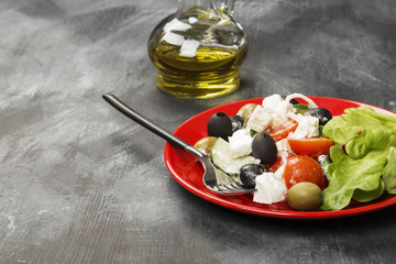 Greek salad feta, cherry tomatoes, olives, cucumbers on a dark background. Copy space. Food background
