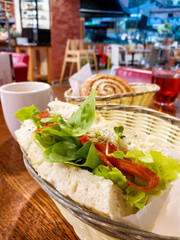 Sandwich with chicken, cheese and golden French fries potatoes