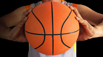 Basketball ball and Basketball player isolated on black background, closeup