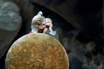 Cropped shot of a Spartan warrior in battledress standing in fighting stance ready to attack with...