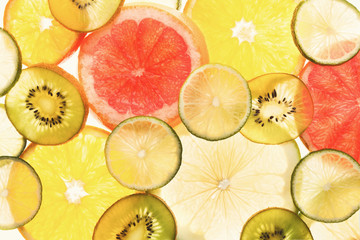 Fototapeta na wymiar Backlit citrus fruits slices background