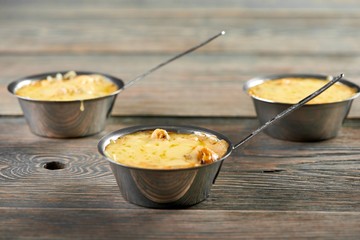 A little bowl with delicious julienne including chicken meat and mushrooms. Tasty hot restaurant dish srved on wooden table.