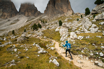 A single hiker walking up a beautiful mountain trail in the Dolomite mountains  - 185131192