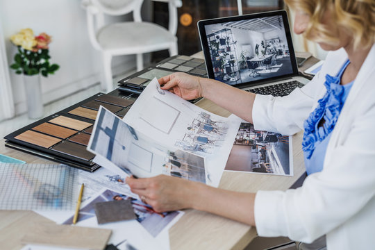 Hands of unrecognisable woman interior designer working with sketch at her office.