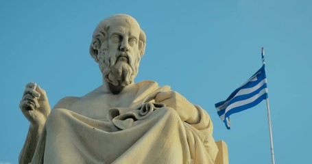 Close-up of a marble statue of the great Greek scholar of antiquity of Plato on background of the national flag of Greece.