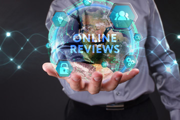 The concept of business, technology, the Internet and the network. A young entrepreneur working on a virtual screen of the future and sees the inscription: Online reviews