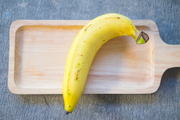Ripe banana fruit on wooden tray
