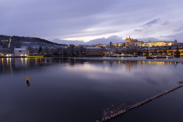 Naklejka premium Christmas night snowy Prague Lesser Town with Charles Bridge and Prague Castle, Czech republic