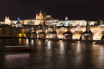Christmas night snowy Prague Lesser Town with Charles Bridge and Prague Castle, Czech republic