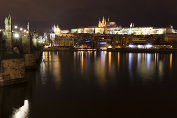 Christmas night snowy Prague Lesser Town with Charles Bridge and Prague Castle, Czech republic
