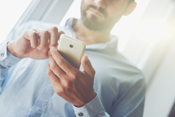 Handsome businessman using smart phone