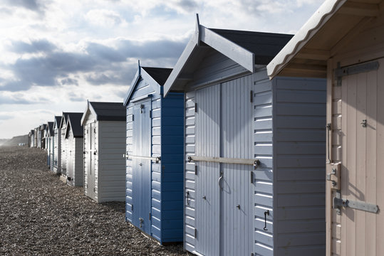 Beach huts against cloudy sky