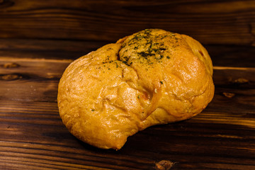 Italian bun ciabatta with garlic on wooden table