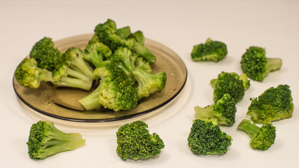 Frosen broccoli in a glass bowl on a wooden surface