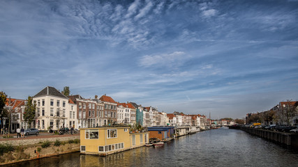 Big canal in Middelburg with houseboats and traditional dutch houses