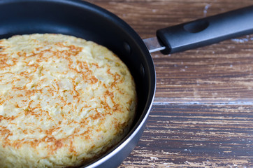 Homemade tortilla in frypan, Spanish omelette popular tapas or snack Spain.