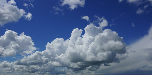 cloudscape. white cumulus clouds against blue sky background