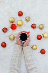 Top view on the red cup of coffee with Christmas decorations