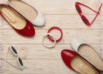 Women's shoes and sunglasses of red and white color.