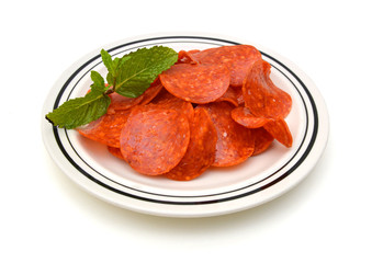 Slices of pepperoni on white background