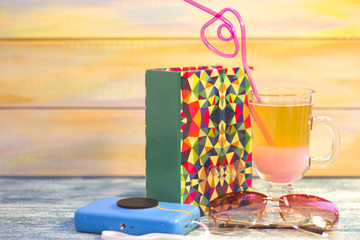 Vacation items on a blue wooden table