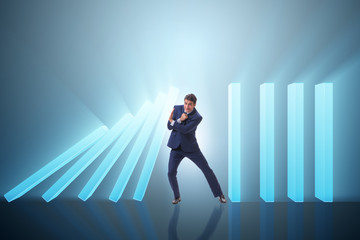 Fototapeta premium Businessman in domino effect business concept
