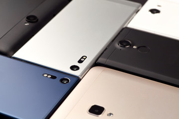 Background of smartphones and tablets, kind of at an angle.