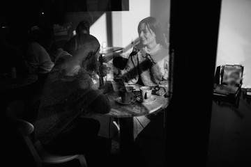 Fototapeta na wymiar Two cheerful young loving people who drank coffee at coffee shops