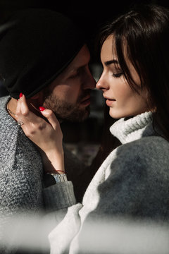 Portrait beautiful couple in stylish clothes in gray tones, city