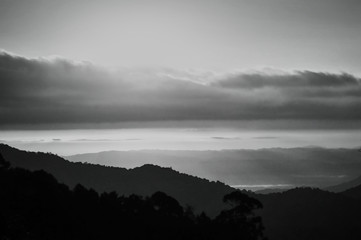 Mountain picture with clouds in the morning, black and white image.