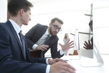 Fototapeta premium Two businessmen talking about new opportunities sitting with pc