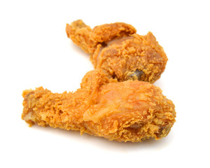 Golden brown fried chicken drumsticks on white background