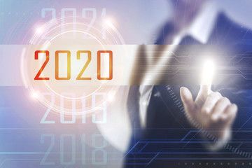 Business women touching the 2020 screen